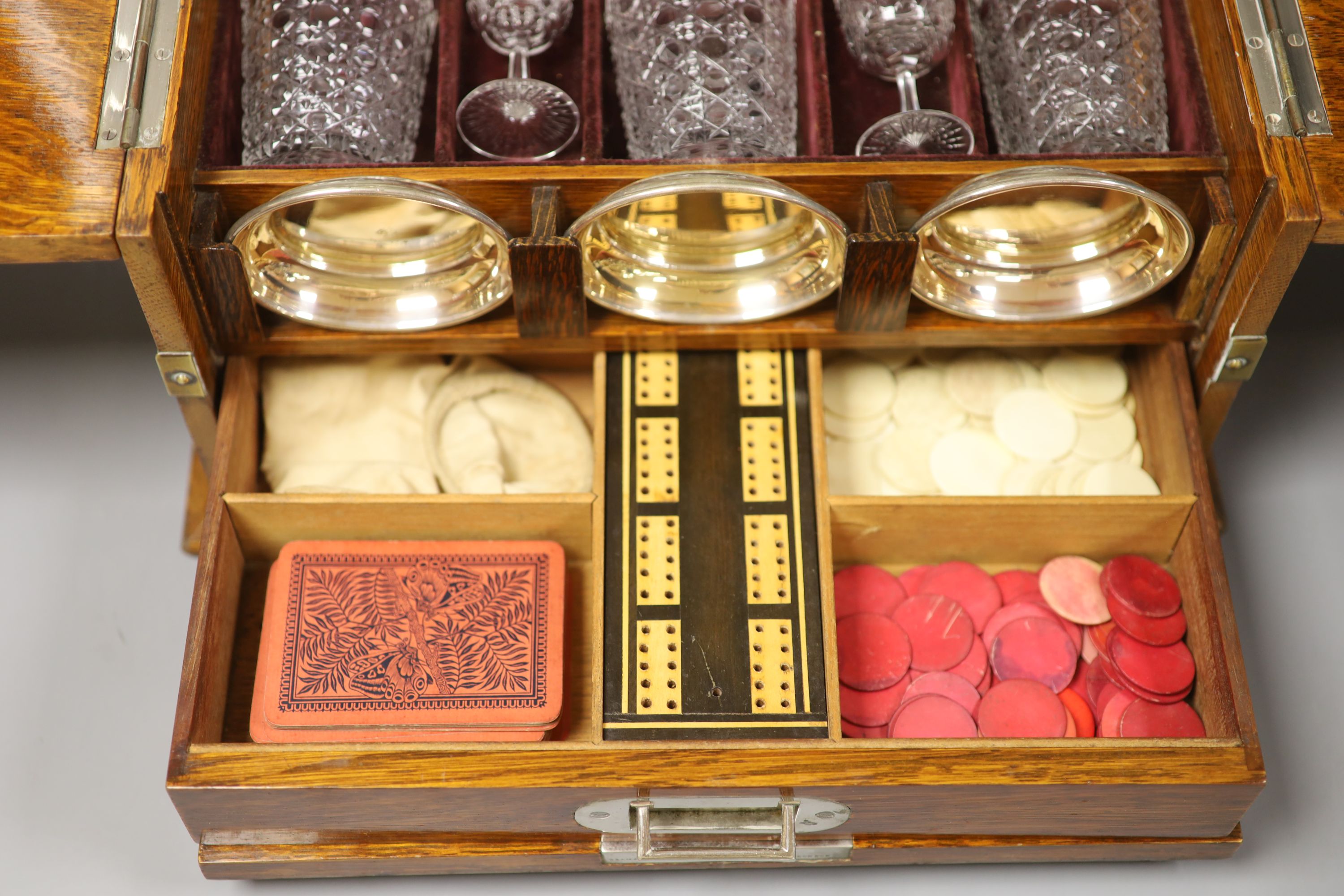 A good Victorian oak and brass mounted tantalus and combination games box, height 35.5cm width 36cm depth 30cm